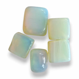 Opalite polished cubes, milky opalescent glass with soft blue glow and amber shimmer