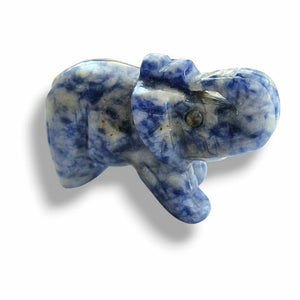 Carved stone elephant with blue and white patterns on a white background