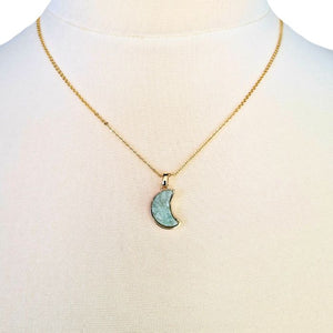 Moon Pendant Necklace featuring a delicate gold chain and a shimmering crescent moon charm.