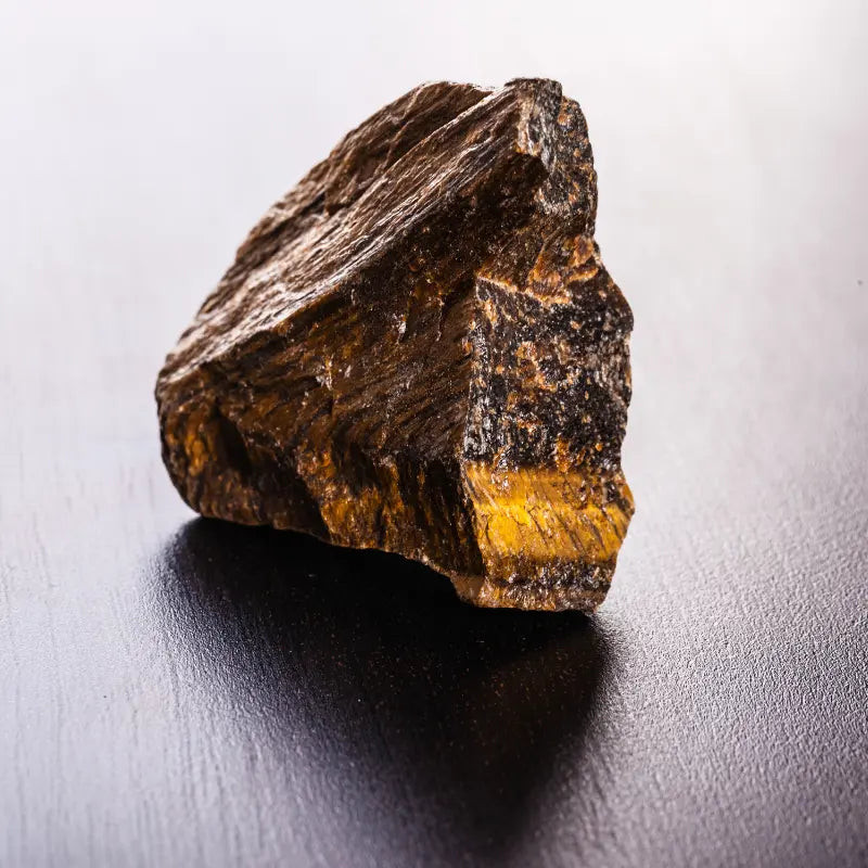 Natural Tiger's Eye stone with rich golden and brown hues, showcasing its unique texture.