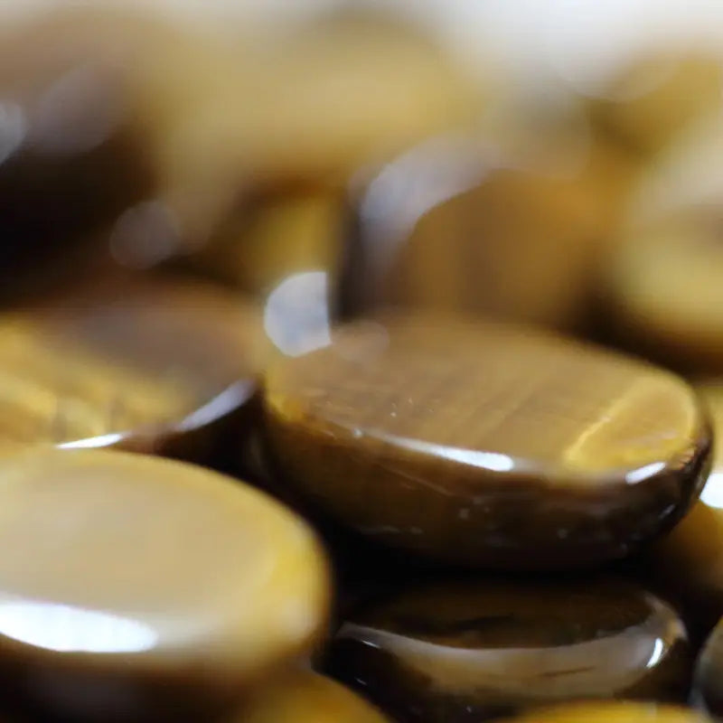 Tiger Eye Stones with smooth, polished surfaces in rich golden brown hues.