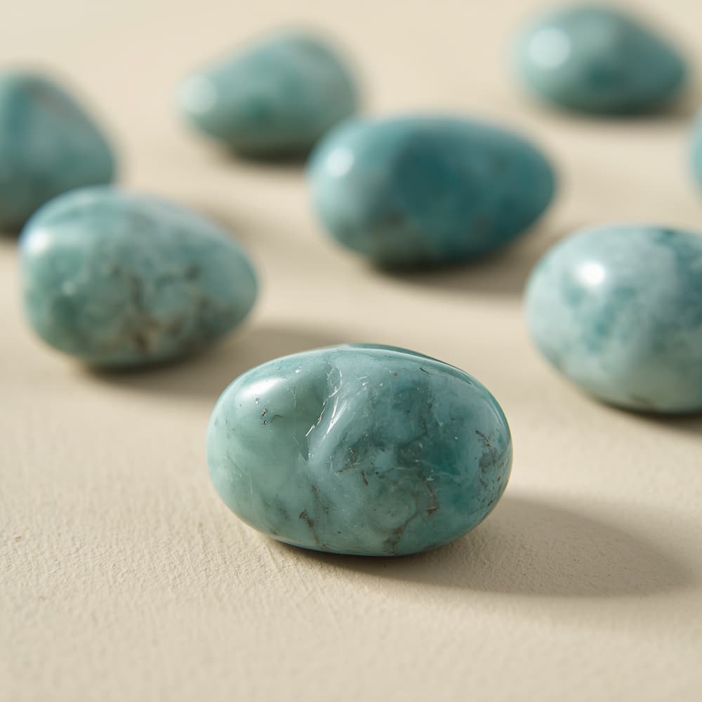 Polished blue-green amazonite stones with natural white veining