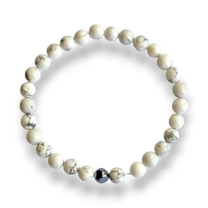 Howlite beaded bracelet with white 6mm beads veined in grey and one silver hematite cube accent