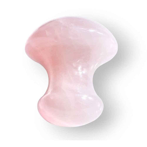 Rose quartz mushroom massage tool in soft pink natural stone